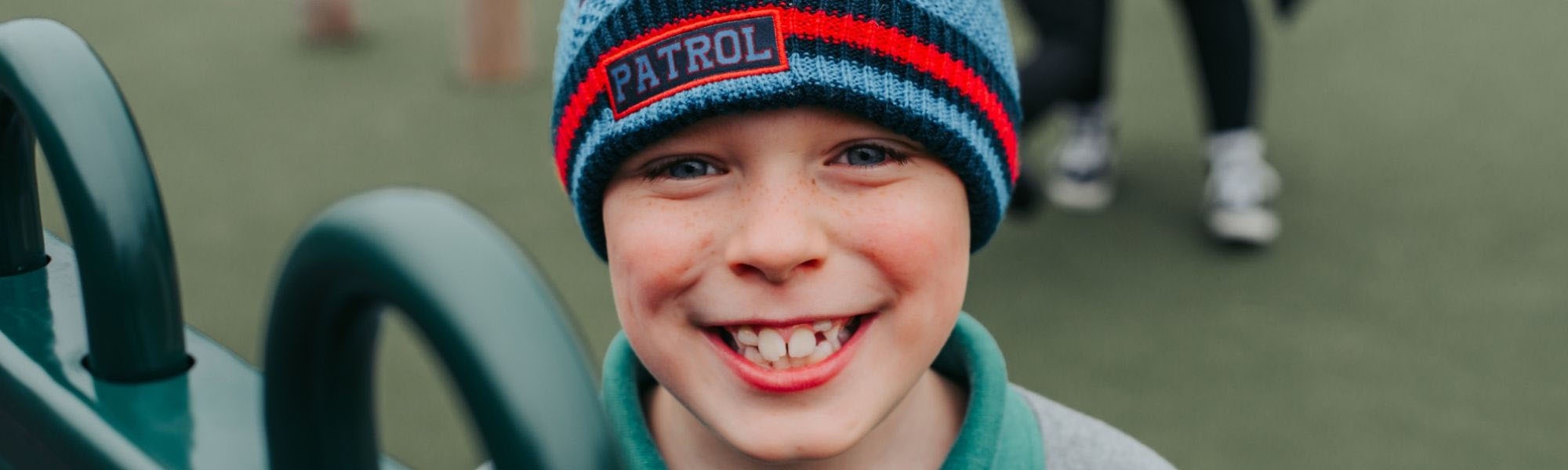 Boy smiles in a school playground