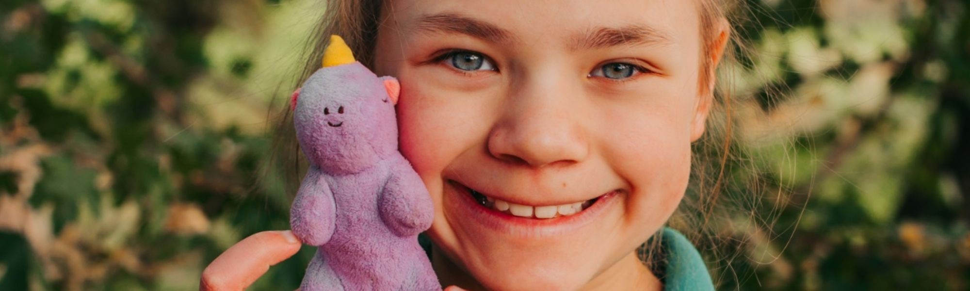 Girl smiles with toy